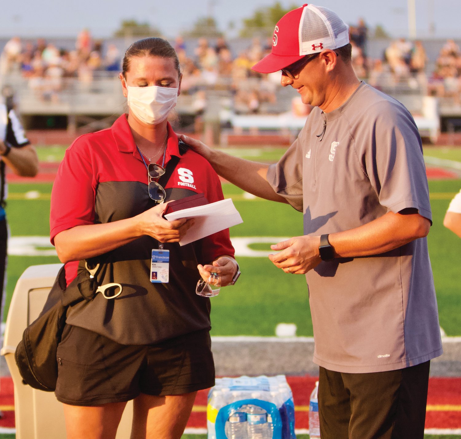 Southmont athletic director Aaron Charles recognizes Kim Chadd before the Southmont football game on August 20. After 17 years as the Mountie athletic trainer, Chadd is stepping into a new role with Franciscan Health.